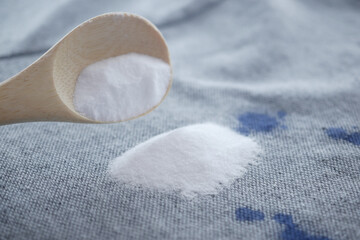 Baking soda on a shirt stain by ink 
