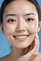 Obraz premium Close-up portrait of smiling young Asian woman with flawless skin
