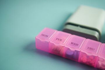 close up of medical pills in a pill box on table 