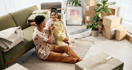 Happy couple, wine and boxes with toast, new home and milestone for bonding together. Woman, man...