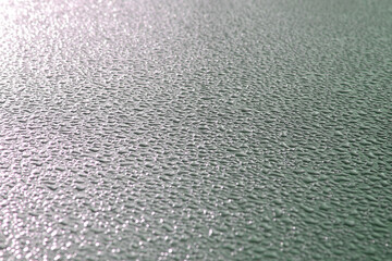 Background of frozen water papels on the hood of a car