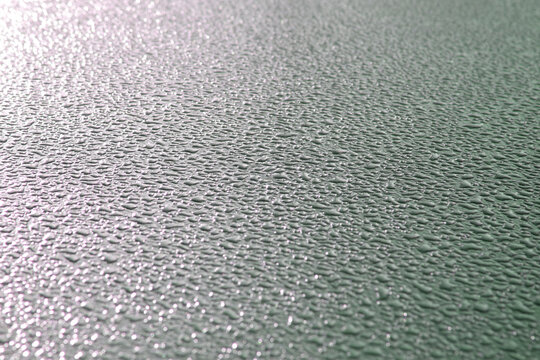 Background of frozen water papels on the hood of a car