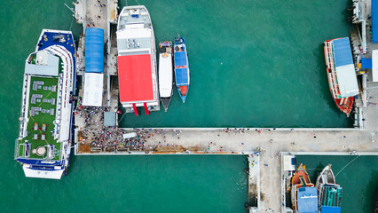 aerial top down of pier in pattaya with tourist boarding the boat for visiting Ko Lan island gulf...