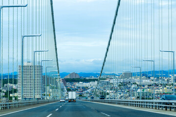 Drive on the Akashi Kaikyo Bridge, that's the world's longest suspension bridge, and connects Kobe...