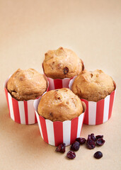 Cranberry wholemeal muffins on brown background