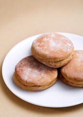 Homemade cheddar wholemeal buns on a white plate