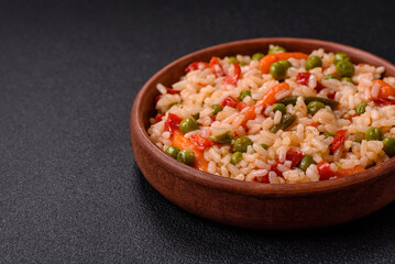 Delicious boiled rice with vegetables carrots, peas and peppers