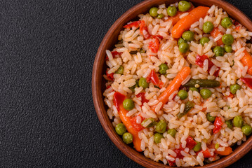 Delicious boiled rice with vegetables carrots, peas and peppers