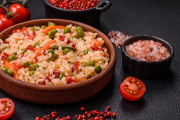 Delicious boiled rice with vegetables carrots, peas and peppers
