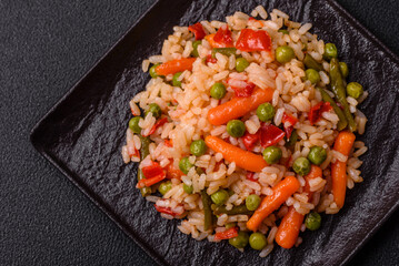 Delicious boiled rice with vegetables carrots, peas and peppers