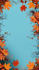 Autumn leaves and branches with vibrant colors framing a bright blue background, creating a seasonal border effect.