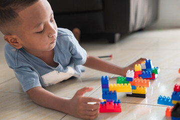 A boy is playing a disassembling game at home