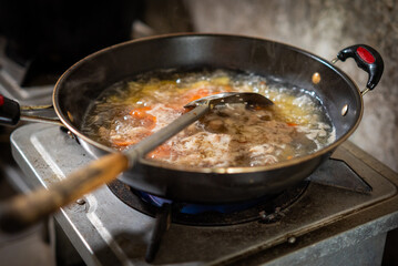 Soup being cooked in a simple kitchen