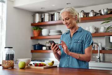 Mature woman, kitchen and cellphone for mobile recipe, cooking and read for instructions online....