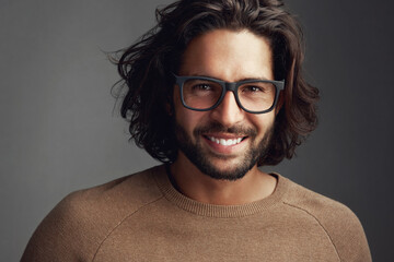 Fototapeta premium Studio, eyewear or portrait of happy man with glasses, vision or clear sight on grey background. Prescription product, smile or confident male model for modern style, fashion or cool spectacle frame