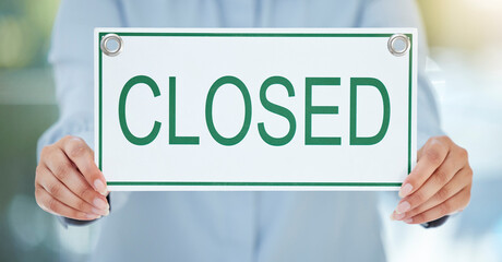 Hands, business and woman with closed sign, employee and recession with inflation. Closeup, entrepreneur and consultant with poster, anxiety or notice for bankruptcy, startup and stress with economy