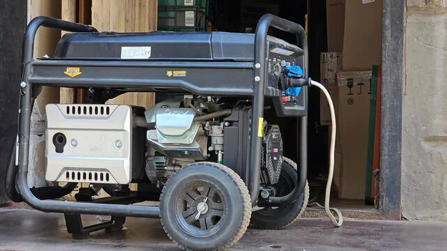 A working power generator is placed on the sidewalk. Outdoor diesel electric generator in Ukraine.