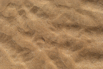 Texture of beach sand washed by the sea with ripple.