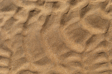 Texture of beach sand washed by the sea with ripple.