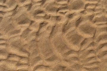 Texture of beach sand washed by the sea with ripple.