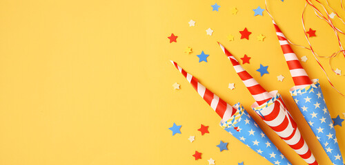 Obraz premium Fiery red, white & blue firework balloons on yellow background