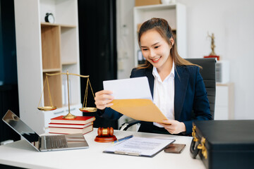 Asian lawyer woman working with a laptop and tablet in a law office. Legal and legal service concept.