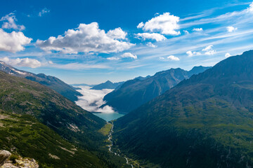 Fototapeta premium Alpine Lake in the Sunlight: Stunning View of the Schlegeis Reservoir