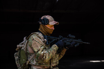Soldier in camouflage with an automatic rifle