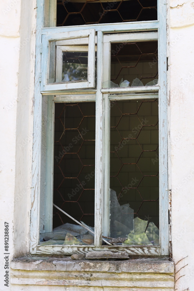 Poster a picture of a broken window with a shattered pane of glass, often used for illustrations about acci