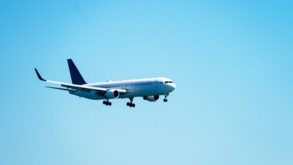 Passenger plane landing in blue sky