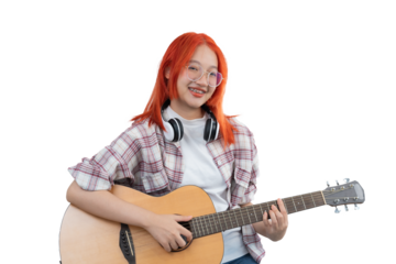 A girl with red hair and glasses is playing a guitar. She is smiling and she is enjoying herself. Isolated on white background.