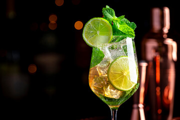 Popular summer cocktail drink with sparkling wine, elderflower syrup, soda, lime, mint and ice in...
