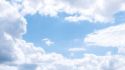 Blue sky with soft fluffy clouds, cloud frame with space for text