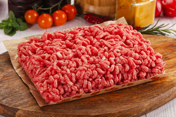 Raw minced beef meat over board