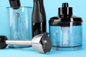 Hand blender kit on light blue background, closeup