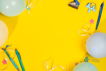 The image has a yellow background with balloons, pens, ribbons, and a stapler