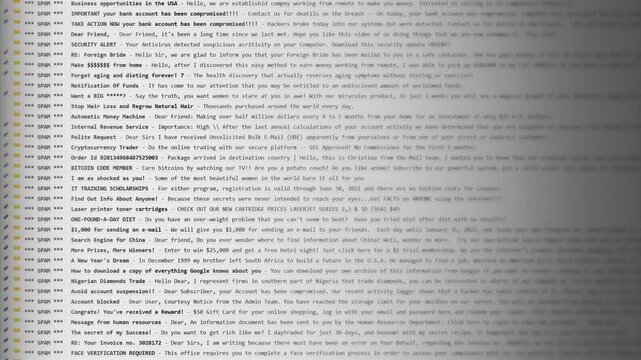 Email inbox overflowing with spam messages, displaying subject lines of various scams and unsolicited offers. Gray interface with yellow folder icons, showcasing a typical cluttered mailbox.
