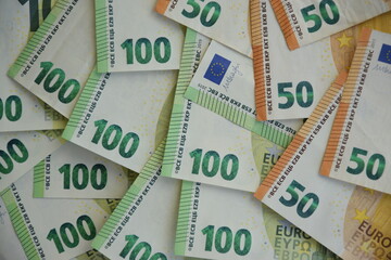 Many banknotes of 100 and 50 Euro bills, the European currency as concept of income