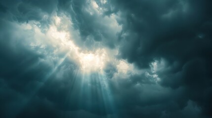Sun rays breaking through dark storm clouds