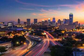 Fototapeta premium Urban Nightfall: Panoramic City Skyline at Dusk with Twinkling Lights and Busy Highways