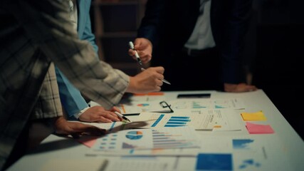 Diverse business team collaborating, analyzing financial charts, discussing strategies, and making decisions in a meeting environment