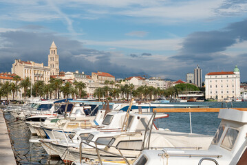 Matejuska old port with small boats. View of Split historic city with Diocletian's Palace bell tower (Cathedral of Saint Domnius) and the Harbour Master's Office - Split, Croatia