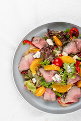 Roast beef salad with cherry tomatoes and orange