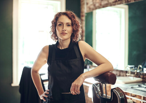 Hair care, tools and portrait of woman in barbershop with stylist, hairdresser or small business owner. Confidence, about us and serious female barber with scissors, pride and professional in salon