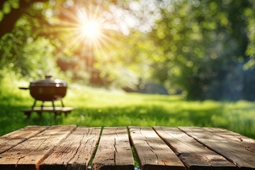 Fototapeta premium Empty wooden table with a barbecue on a sunny summer day in the park