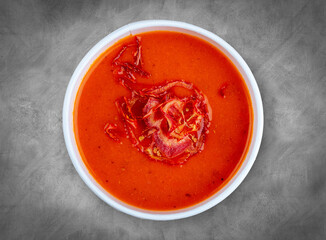 Tomato soup. Healthy food. Takeaway food. Top view, on a gray background.
