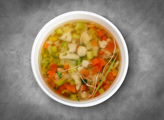 Ministerone - vegetable soup. Healthly food. Takeaway food. Top view, on a gray background.