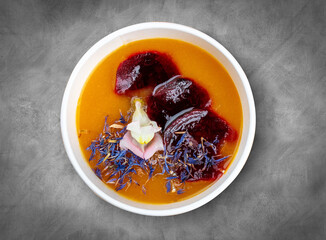 Pumpkin cream soup. Healthy diet. Takeaway food. Eco packaging. Top view, on a gray background.