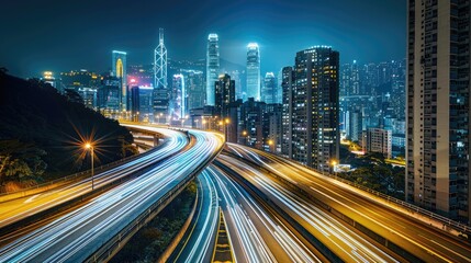 Fototapeta premium Light trails on a highway overpass, with city skyscrapers illuminated at night.