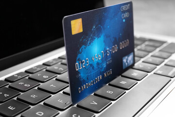 Laptop with credit card on table, closeup